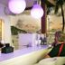 Holland House Beach Hotel bar with bartender serving drinks and harbor sunset view in Philipsburg