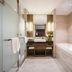 Henan Sky-Land Gdh Hotel in Zhengzhou bathroom with glass shower, vanity, and built-in tub