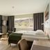 Hotel Katla by Keahotels room in Vik with twin beds and large windows overlooking hills