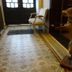 La Maison De Maitre in Arbrefontaine: hallway with tiled floor, chair by the door, and a standing taxidermy fox