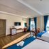 Brenta Phu Quoc Hotel room with twin beds, balcony ocean view, and wall-mounted TV