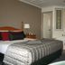 Old Coach Motor Inn Echuca room with bed, spa tub and wall mirror