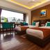 Hotel Jagjeet, Darjeeling guest room with two beds, wood flooring, and large window view