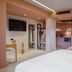 Pavo Art Hotel in Heraklion guest room with bed, seating area, kitchenette and wall art