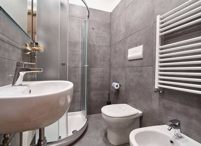Sweet Central Hotel Caserta bathroom with walk-in shower, wall-mounted sink, toilet and towel radiator