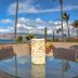Kohea Kai Hotel Maui in Kīhei with ocean-view patio, glass table, palm trees and planter pots