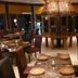 Omali São Tomé restaurant interior with round tables and woven pendant lighting
