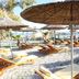 Bunec Beach Resort in Lukovë with sun loungers and straw umbrellas on a pebble beach