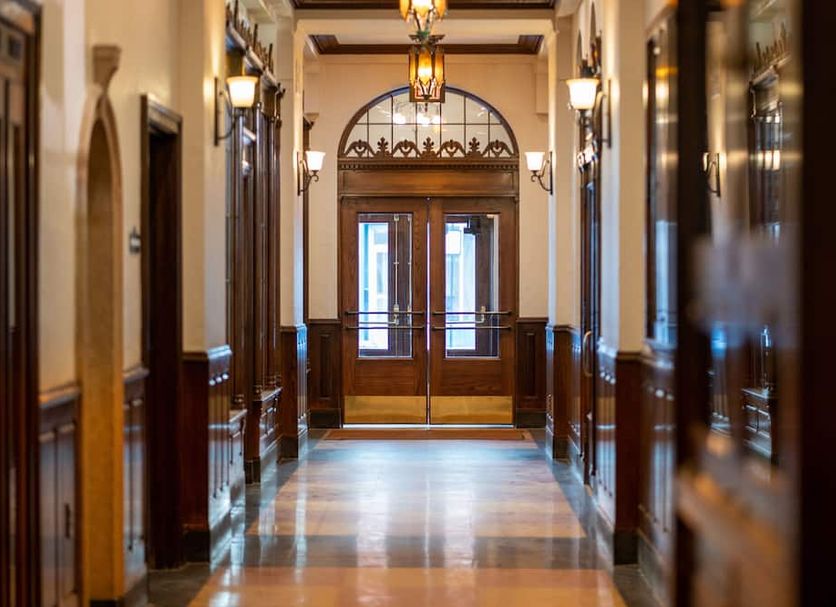 The Alonzo Ward Hotel in Aberdeen hallway with wood trim, lantern-style lights, and double doors