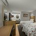 Red Roof Inn Greensboro Airport room in Greensboro with two beds, desk, and vanity area