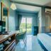 The Rubber Hotel (Sha Plus+) guest room with bed, balcony view, desk, and air conditioner in Thep Krasattri