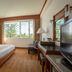 Centara Life Hotel Mae Sot guest room with large window and wood furnishings in Mae Sot