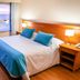 Yene Hue hotel room in Puerto Madryn with ocean view, king bed, and large windows