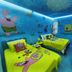 Pousada Caminho Dos Sonhos room in Penha with SpongeBob-themed beds and blue mural walls