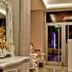 Rota Bulvar Hotel in Ankara lobby with ornate mirror, floral arrangement, and seating by glass doors