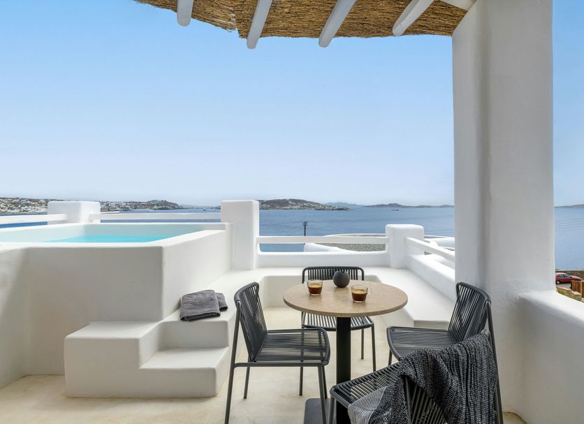 Rocabella Mykonos Hotel in Agios Stefanos: terrace with table, chairs and sea view