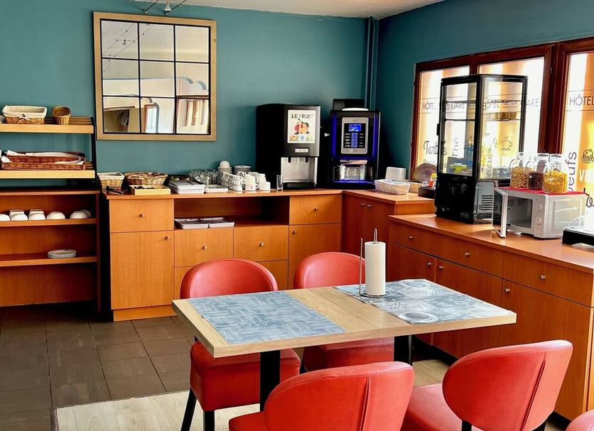 Hotel de la Gare in Aix-les-Bains breakfast area with coffee machine, buffet shelf and tables