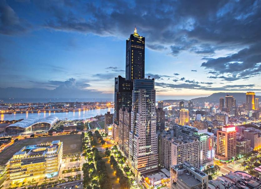 Ct Theme Suite in Kaohsiung City skyline view at dusk with illuminated high-rise buildings and waterfront