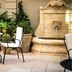The Reserve at Park MGM in Las Vegas with an outdoor patio table, chairs, and stone fountain
