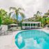 Noosa Hill Resort in Noosa Heads with a turquoise outdoor pool, loungers, palms and resort buildings