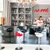 Hotel Le Cinéma bar in Gatteo with striped wall, chandelier, and colorful stools
