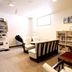 Lodge Koropokkuru in Niseko lounge with seating, bookshelves, table, and vending machine