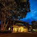 Anda Bettei Izu Ippekiko Resort in Itō, illuminated hotel entrance at dusk with surrounding trees