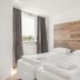 Stay Apartments Einholt Reykjavik double bedroom with wood headboard and window with curtains