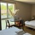 Hôtel La Métairie in Cordes-sur-Ciel room with bed, table, chairs, and window view