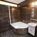 Residence U Cerne Veze bathroom with bathtub, sink, shower, and dark tiled walls in České Budějovice
