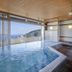 Kamenoi Hotel Atami Annex indoor hot spring pool with ocean and hillside view in Atami