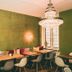 Hotel Villa Klemm - Wiesbaden City lounge with green walls, chandeliers and wooden tables in Wiesbaden