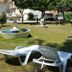 Hotel La Costera in A Lanzada: garden with lounge chairs, fountain, and palm trees