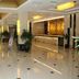 Shell House Hotel in Baoding lobby with glossy tiled floor, reception desk, and seating area