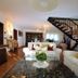 Agriturismo - B&B L'Acquacotta lounge with sofas, staircase, dining area and tiled floors in Castiglione della Pescaia