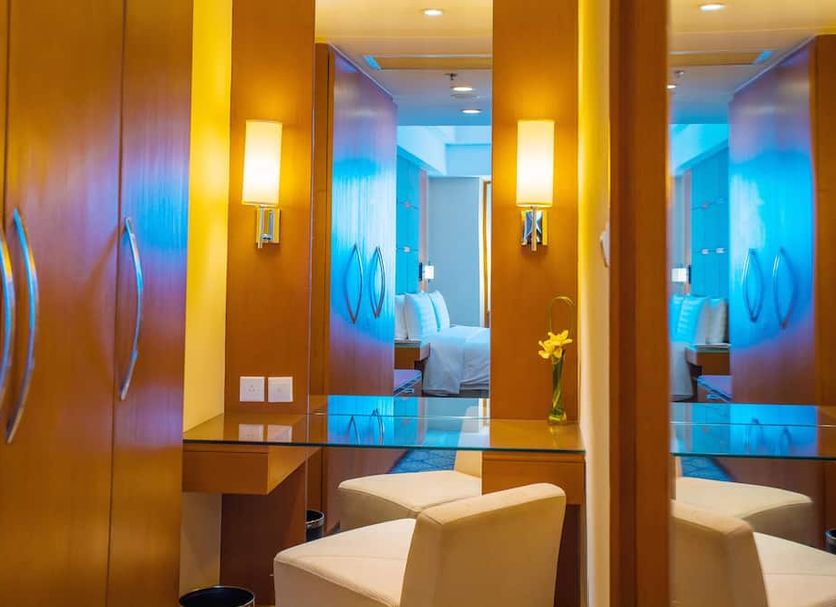 Shangri-La Baotou guest room vanity area with mirrored panel, wall sconces and seating
