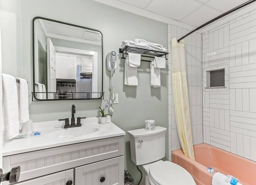 The Crest - Hampton Beach bathroom with vanity, toilet, shower-tub, and wall mirror in Hampton Beach