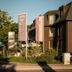 Hotel Trezor in Singen exterior with flags, greenery, and modern building facade