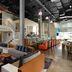 Aloft Seattle Redmond lobby with lounge seating, staircase, bar area, and high ceilings in Redmond
