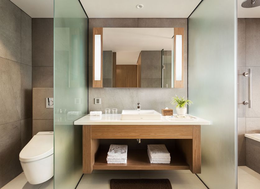 Hotel Emion Phnom Penh bathroom with glass shower, modern vanity, and toilet in Phnom Penh
