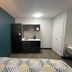 Studio 6 Huntsville, Alabama University Drive room with kitchenette, teal accent wall, and patterned bedspread