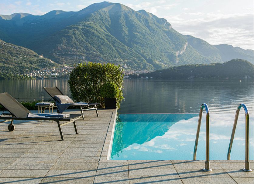 Filario Hotel & Residences in Lezzeno with lakefront pool, loungers, and mountain views