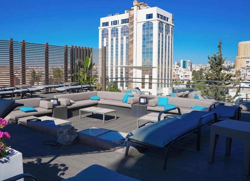 The House Boutique Suites rooftop terrace in Amman with lounge seating and city views
