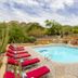 Gold Canyon Golf Resort pool with red loungers, desert landscaping, and mountain views in Gold Canyon