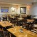 Tongadale Hotel in Portree dining room with wooden tables and chairs in a cozy restaurant
