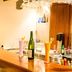 Hotel Supreme Heritage Navi Mumbai bar counter with bottles, cocktail shakers and hanging glasses