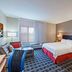 TownePlace Suites by Marriott Tulsa North/Owasso guest room with king bed, sofa, desk and TV in Owasso