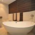 Apollo Hotel Johannesburg bathroom with freestanding soaking tub, vanity sink and large mirror