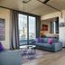 Downtown Apartments Mitte Berlin apartment interior with sofa, balcony door and city view