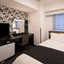 APA Hotel Higashi Nihombashi Ekimae guest room in Tokyo with bed, desk, and window view